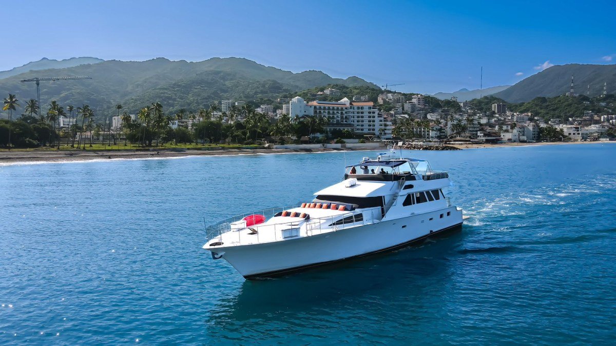 A 90 ft Cheoy Lee luxury motor yacht cruising along the Puerto Vallarta coastline on a day charter