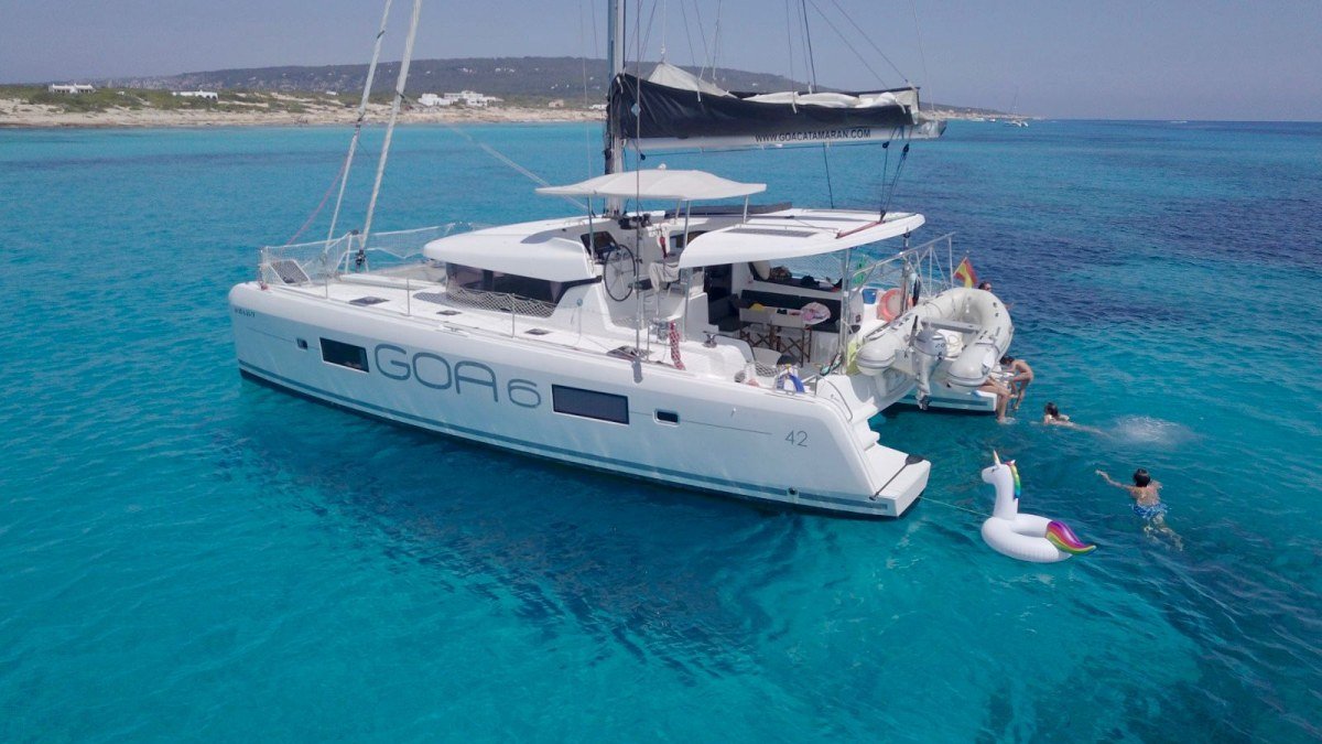 Guests swimming off a Lagoon 42 catamaran charter anchored in turquoise water off La Cruz de Huanacaxtle