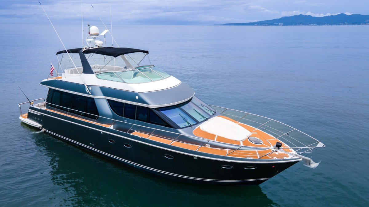 The 60 ft Baltra motor yacht cruising off La Cruz de Huanacaxtle with the Sierra Madre behind, available for charter from Marina La Cruz