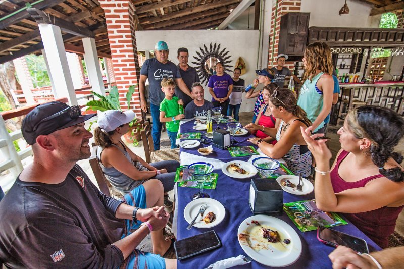 Guests at the lunch table under the palapa at Rancho Capomo