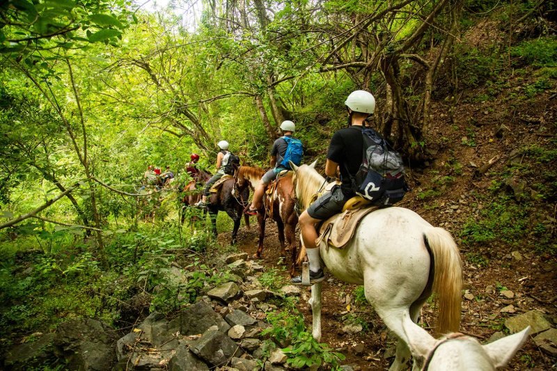 Rider with helmet on the Rancho Capomo horseback trail