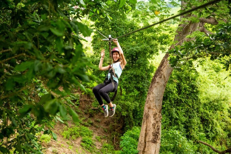 Guide sending a guest down a zipline in the Sierra Madre near Las Palmas
