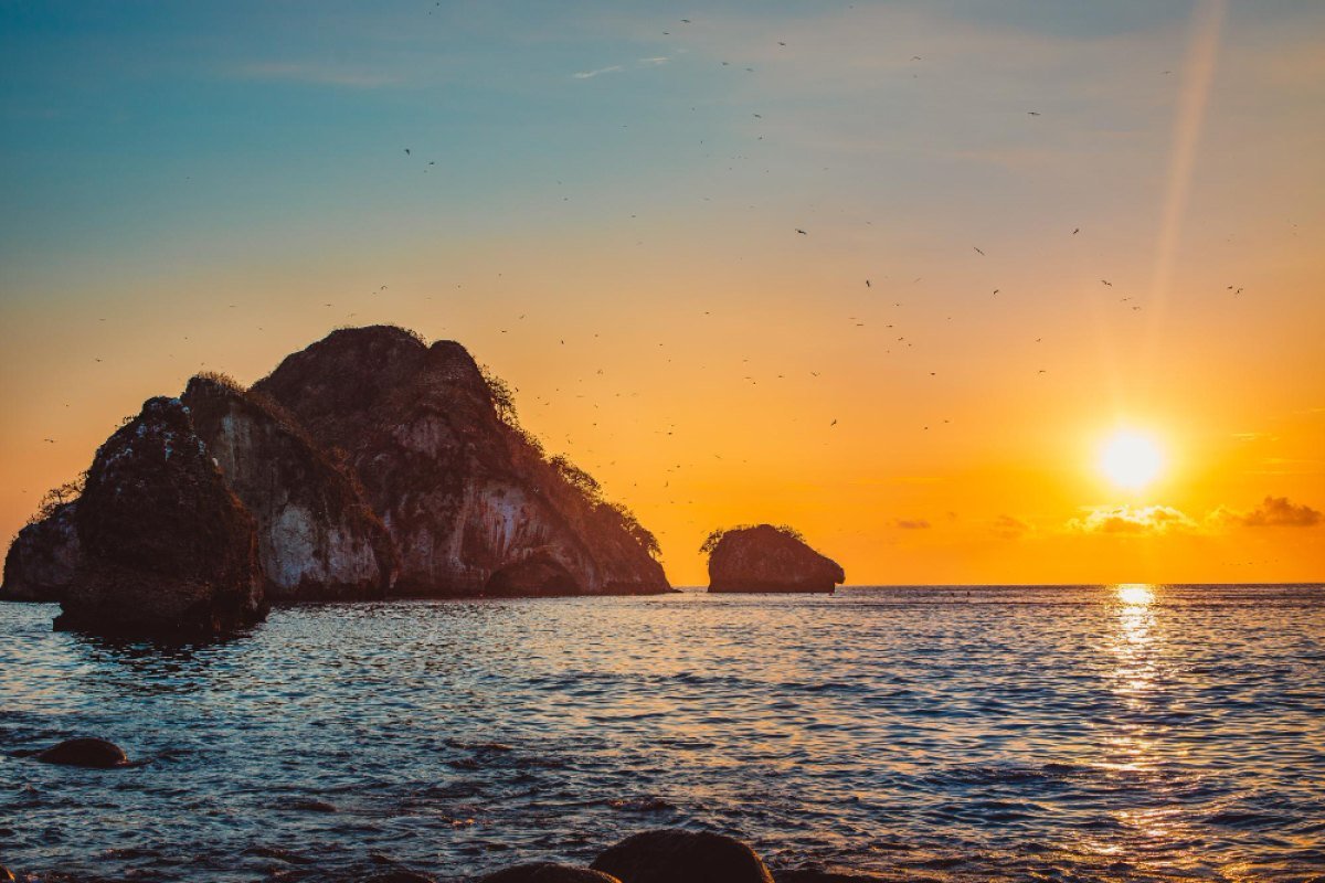 The rock arches of Los Arcos de Mismaloya silhouetted at sunset in Banderas Bay