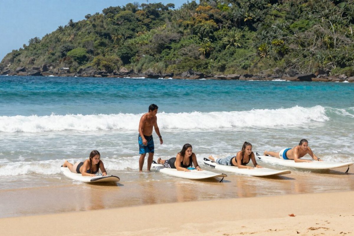 Surf instructor teaching the pop-up to a group on the sand before going into the water